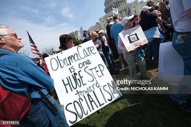 Supporter of the Tea Party movement holds a sign outside the US Capitol as they demonstrate in Washington on March 21, 2010 against the health care...