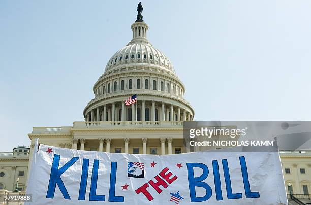 Supporters of the Tea Party movement hold a sign outside the US Capitol as they demonstrate in Washington on March 21, 2010 against the health care...