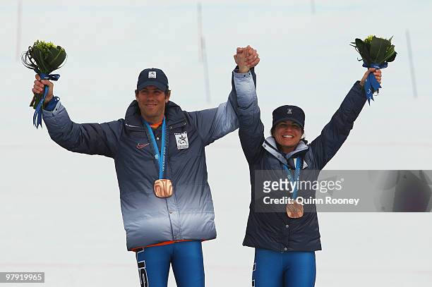 Bronze medalist Danelle Umstead of USA and guide Rob Umstead celebrate at the medal ceremony for the Women's Visually Impaired Super Combined during...