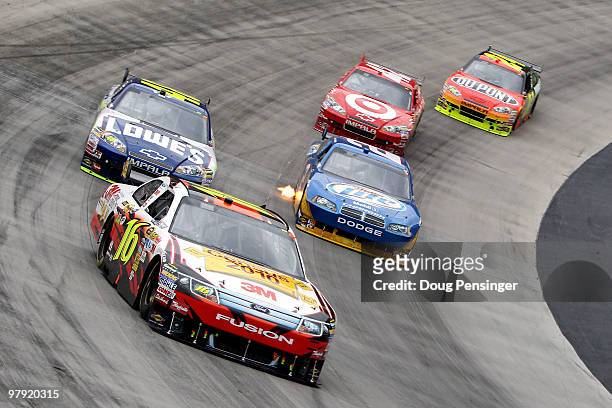 Greg Biffle, driver of the US Census Ford, leads Jimmie Johnson, driver of the Lowe's Chevrolet, Kurt Busch, driver of the Miller Lite Dodge, Juan...