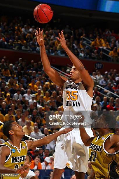 Wellington Smith of the West Virginia shoots against Kim English and Zaire Taylor of the Missouri Tigers Mountaineers during the second round of the...