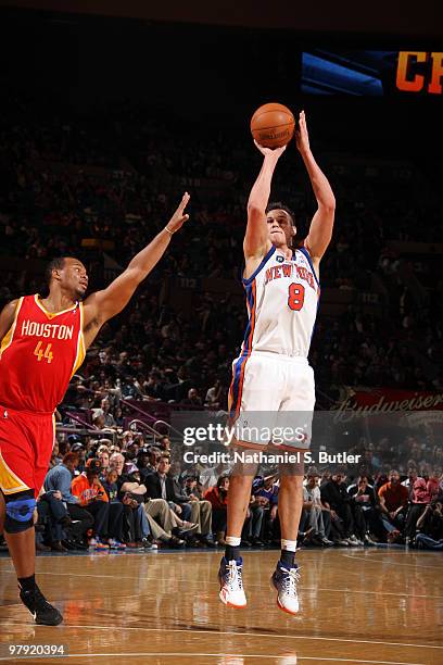 Danilo Gallinari of the New York Knicks shoots against Chuck Hayes of the Houston Rockets on March 21, 2010 at Madison Square Garden in New York...