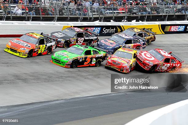 Juan Pablo Montoya, driver of the Target Chevrolet, crashes into Marcos Ambrose, driver of the Little Debbie Toyota, and Mark Martin, driver of the...