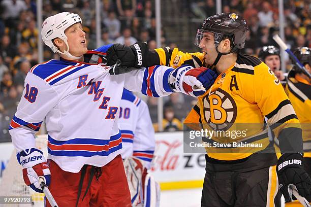 Patrice Bergeron of the Boston Bruins grabs Marc Staal of the New York Rangers at the TD Garden on March 21, 2010 in Boston, Massachusetts.