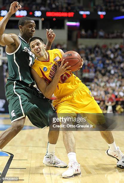 Greivis Vasquez of the Maryland Terrapins drives against Raymar Morgan of the Michigan State Spartans during the second round of the 2010 NCAA men's...