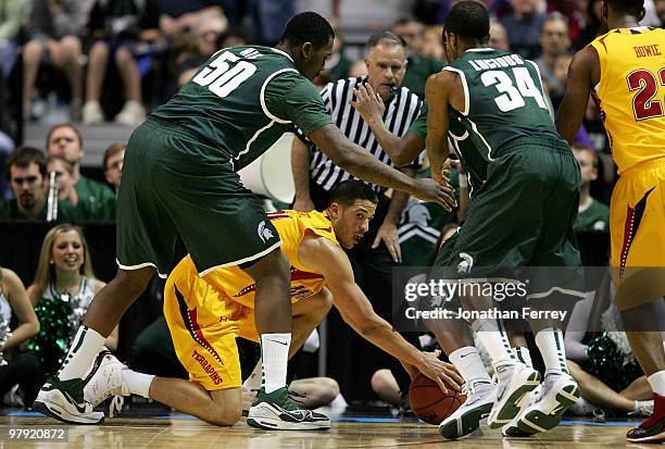 Greivis Vasquez of the Maryland Terrapins is defended by Derrick Nix and Korie Lucious of the Michigan State Spartans during the second round of the...