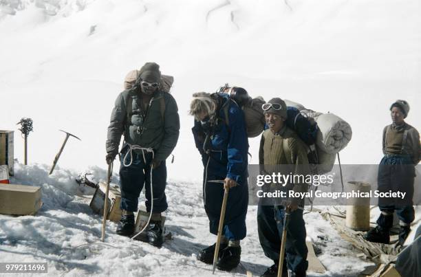 John Hunt with sherpas prepared for ascent with ice-axe, rope and oxygen equipment at Camp IV, Nepal, March 1953. Mount Everest Expedition 1953.