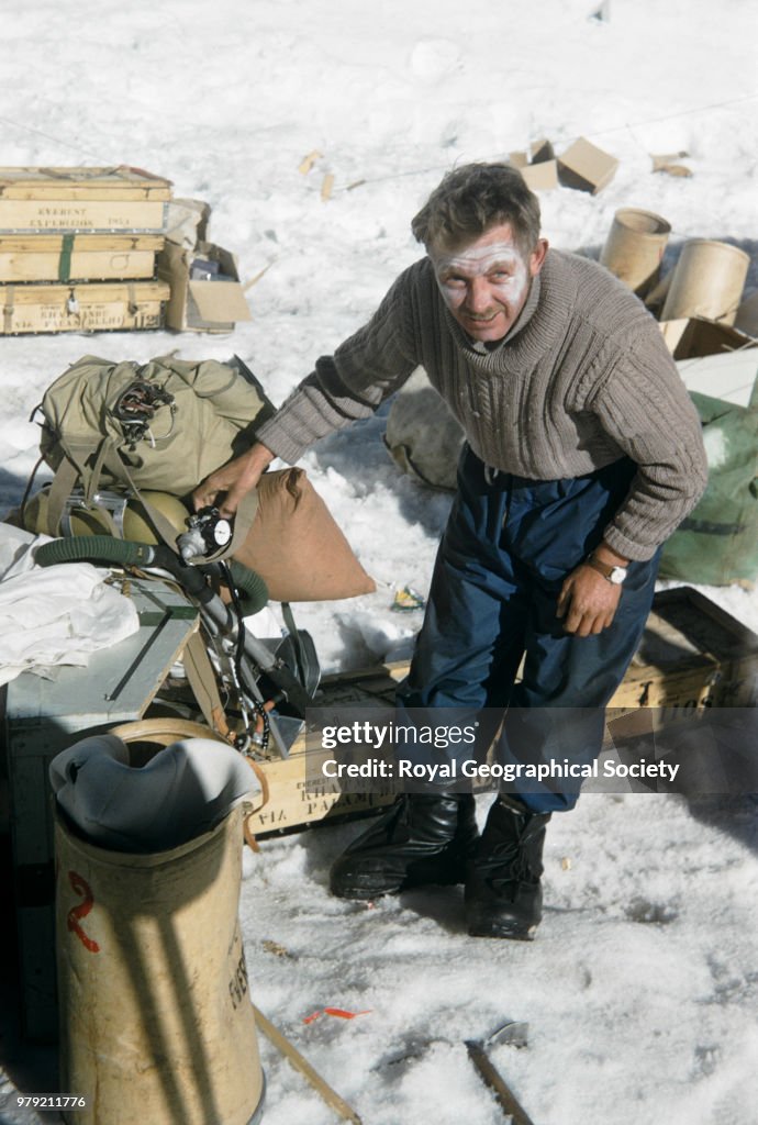 Charles Evans preparing and checking oxygen equipment at Camp IV