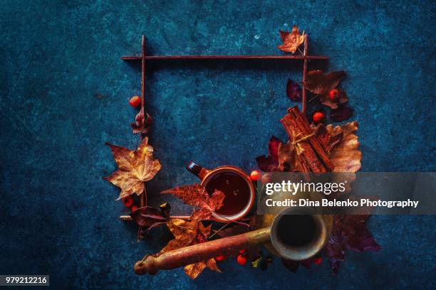 autumn hot coffee with cup and cezve on a stone background with a square wooden frame and maple leaves. artist study flat lay. fall drink still life with copy space. - khabarovsk krai stockfoto's en -beelden