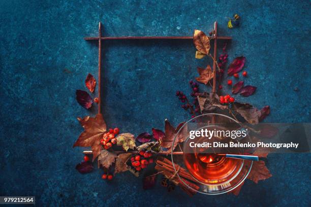 autumn hot tea with a glass tea cup on a stone background with a square wooden frame and maple leaves. artist study flat lay. fall drink still life with copy space. - khabarovsk krai stockfoto's en -beelden