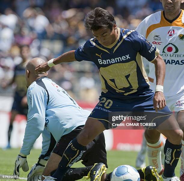 Ismael Iniguez of Pumas shoots to score the first goal against Jaguares goalkeeper Oscar Perez during their Mexican Bicentenario 2010 tournament...