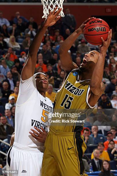 Keith Ramsey of the Missouri Tigers goes to the hoop against Kevin Jones of the West Virginia Mountaineers during the second round of the 2010 NCAA...