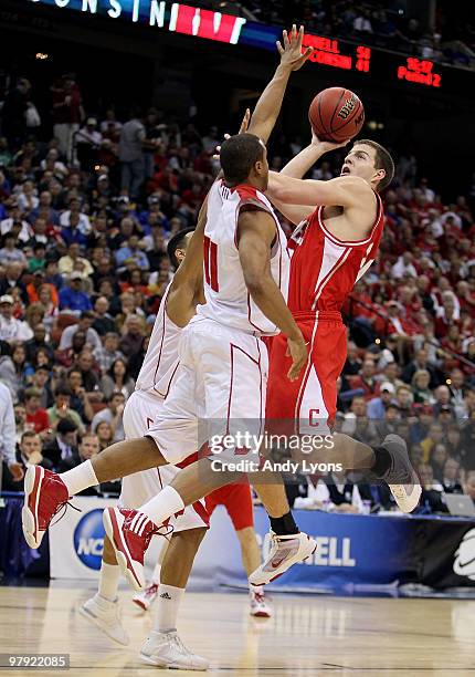 Adam Wire of the Cornell Big Red shoots over Jordan Taylor and Ryan Evans of the Wisconsin Badgers during the second round of the 2010 NCAA men's...