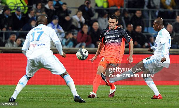 Marseille's forward vies with Lyon's defender Cris vies with Olympique Marseille's Cameroonian midfielder Stephane M'Bia and Olympique Marseille's...