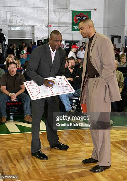 Head coach Dee Brown of the Springfield Armor draws up a play with assistant coach Kevin Whitted during a timeout against the Maine Red Claws during...