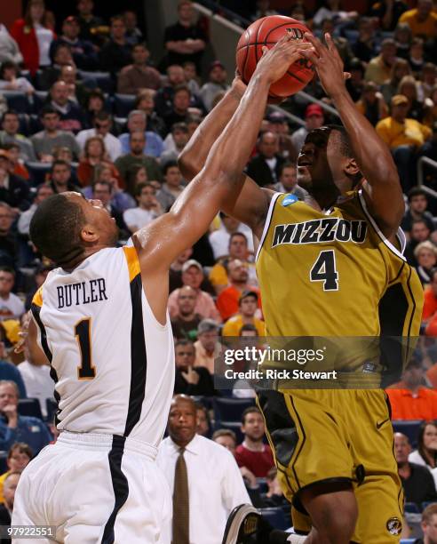 Tiller of the Missouri Tigers gets blocked by Da'Sean Butler of the West Virginia Mountaineers during the second round of the 2010 NCAA men's...