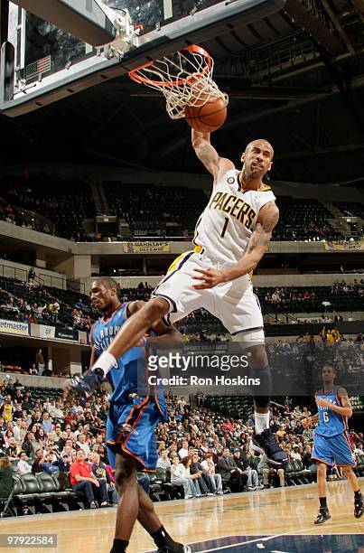 Dahntay Jones of the Indiana Pacers jams over a Oklahoma City Thunder defender at Conseco Fieldhouse on March 21, 2010 in Indianapolis, Indiana. The...