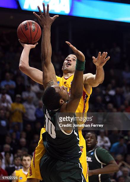 Greivis Vasquez of the Maryland Terrapins shoots over Delvon Roe of the Michigan State Spartans during the second round of the 2010 NCAA men's...