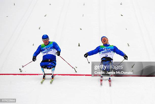 Sergey Shilov of Russia crosses the line ahead of Irek Zaripov of Russia to win gold Men's 1km Sitting Cross-Country Sprint Final during Day 10 of...