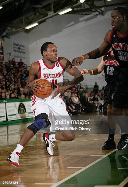 Russell Robinson of the Maine Red Claws cuts to the basket for a shot while guarded by Noel Felix of the Springfield Armor during the game on March...