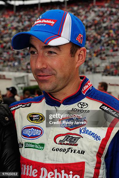 Marcos Ambrose, driver of the Little Debbie Toyota, stands on the grid prior to during the NASCAR Sprint Cup Series Food City 500 at Bristol Motor...