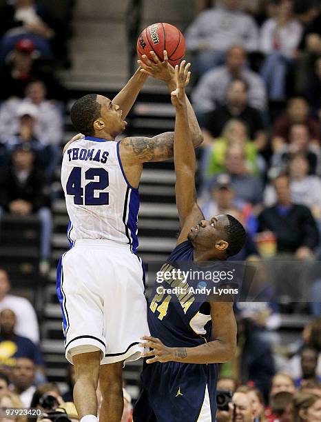 Lance Thomas of the Duke Blue Devils shoots over Theo Robertson of the California Golden Bears during the second round of the 2010 NCAA men's...