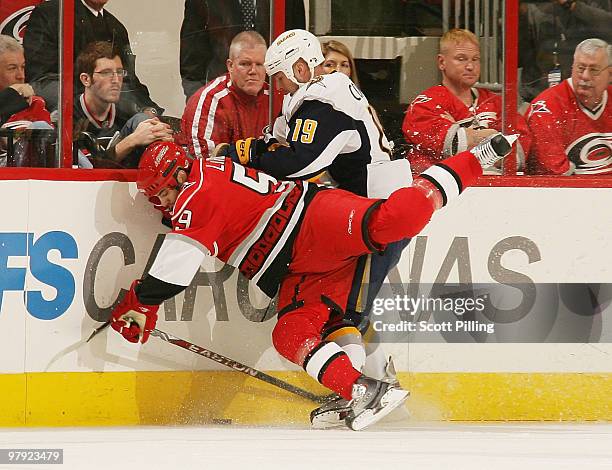 Chad LaRose of the Carolina Hurricanes collides into Tim Connolly of the Buffalo Sabres during their NHL game on March 21, 2010 at the RBC Center in...