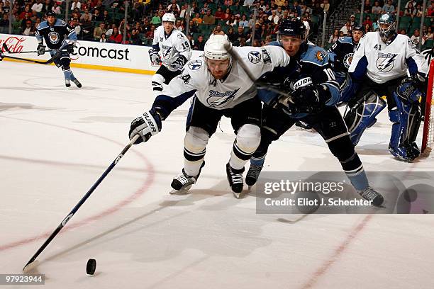 Andrej Meszaros of the Tampa Bay Lightning stretches for the puck against David Booth of the Florida Panthers at the BankAtlantic Center on March 21,...