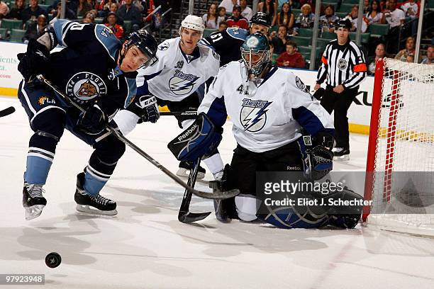 David Booth of the Florida Panthers skates for possession against Goaltender Mike Smith of the Tampa Bay Lightning at the BankAtlantic Center on...