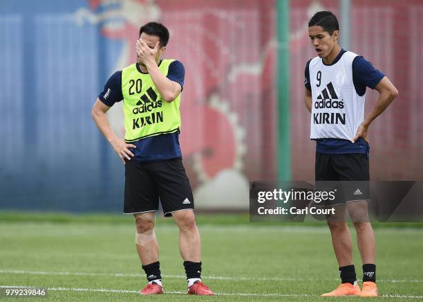 Shinji Okazaki and Yoshinori Muto of Japan look on during a Japan training session during the 2018 FIFA World Cup at the FC Rubin Training Ground on...