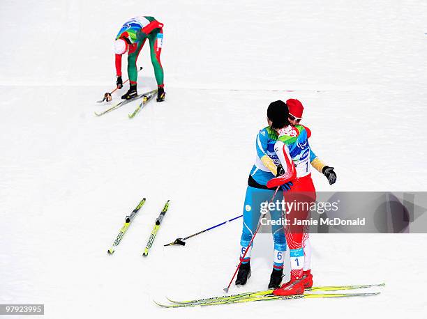 Gold medalist Oleksandra Kononova of Ukraine embraces silver medalist Shoko Ota of Japan after the in the Women's 1km Standing Cross-Country Sprint...