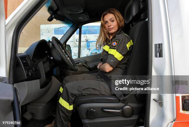 Dpatop - A picture made available on 07 March 2018 shows firefighter Dalia Naamani posing while sitting at the wheel of an ambulance car at Lebanon's...