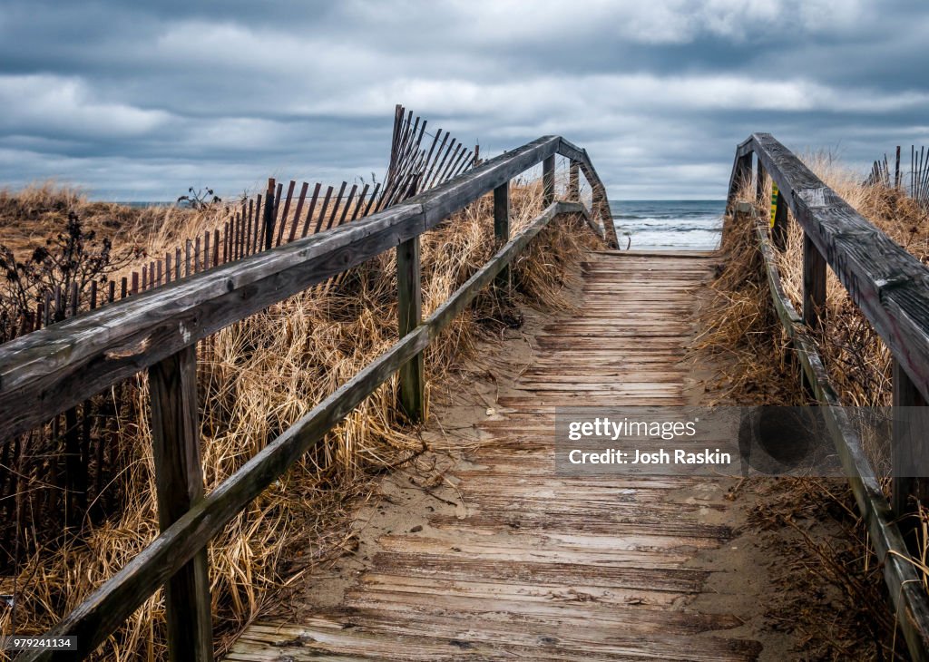 Old boardwalk leading onto beach, Ogunquit, Maine, USA