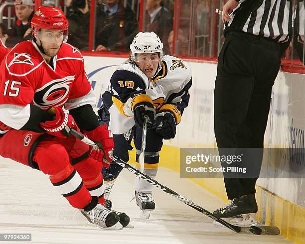 Tim Kennedy of the Buffalo Sabres tries to tie up Tuomo Ruutu of the Carolina Hurricanes during their NHL game on March 21, 2010 at the RBC Center in...