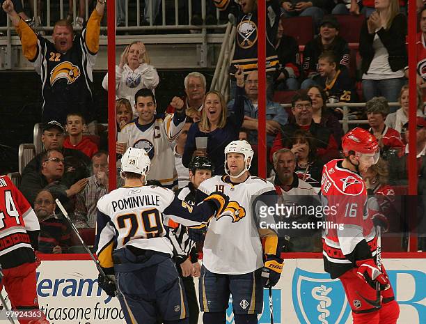 Tim Connolly of the Buffalo Sabres celebrates with teammate Jason Pominville after a goal against the Carolina Hurricanes during their NHL game on...