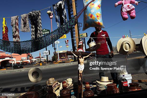 Teenager sells various items on the street March 21, 2010 in Juarez, Mexico. The border city of Juarez has been racked by violent drug related crime...