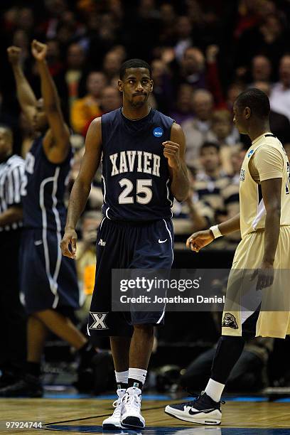 Dante Jackson of the Xavier Musketeers celebrates after as Ashton Gibbs of the Pittsburgh Panthers walks by after the Musketeers defeated the...