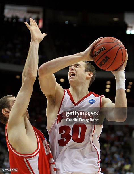 Jon Leuer of the Cornell Big Red drives over Jon Jaques of the Wisconsin Badgers during the second round of the 2010 NCAA men's basketball tournament...