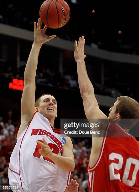 Jason Bohannon of the Wisconsin Badgers scores over Ryan Wittman of the Cornell Big Red during the second round of the 2010 NCAA men's basketball...