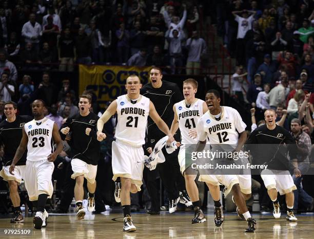 Members of the Purdue Boilermakers rush the court in celebration after defeating the Texas A&M Aggies 63-61 in overtime during the second round of...