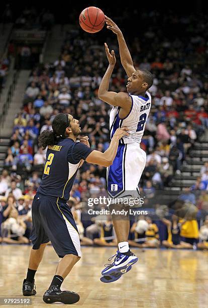 Nolan Smith of the Duke Blue Devils passes the ball while defended by Jorge Gutierrez the California Golden Bears during the second round of the 2010...