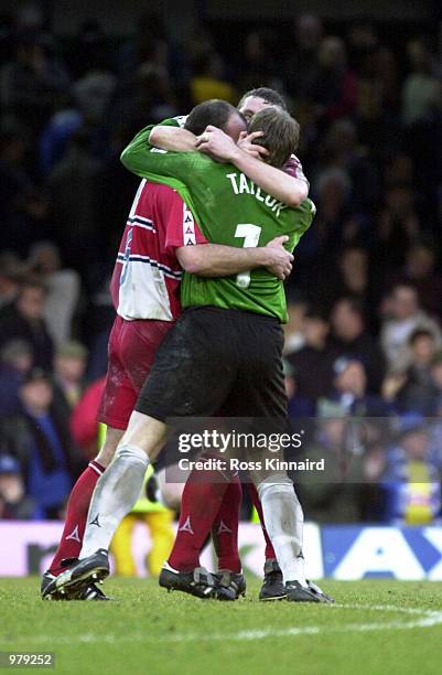 Jamie Bates, Martin Taylor and Paul McCarthy of Wycombe celebrate after beating Leicester City in the quarter final of the FA Cup after the Leicester...