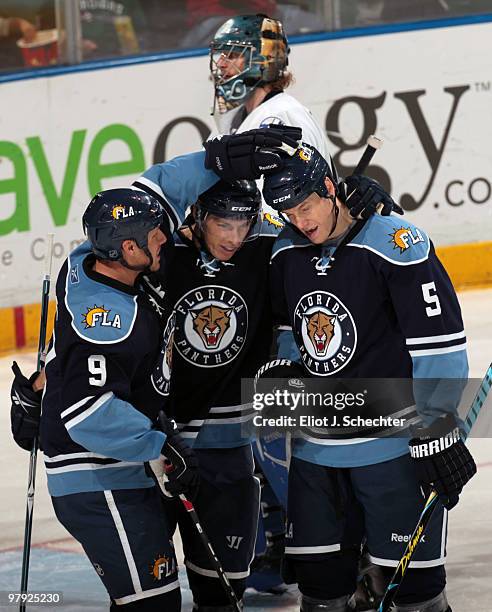 David Booth of the Florida Panthers celebrates a goal with teammates Stephen Weiss and Bryan Allen against the Tampa Bay Lightning at the...