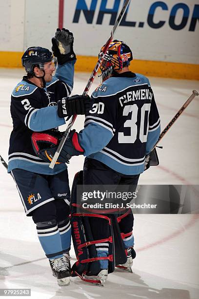 Keith Ballard of the Florida Panthers celebrates their win with teammate Goaltender Scott Clemmensen against the Tampa Bay Lightning at the...