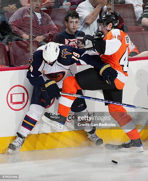 Danny Briere of the Philadelphia Flyers collides with Marty Reasoner of the Atlanta Thrashers against the boards on March 21, 2010 at the Wachovia...