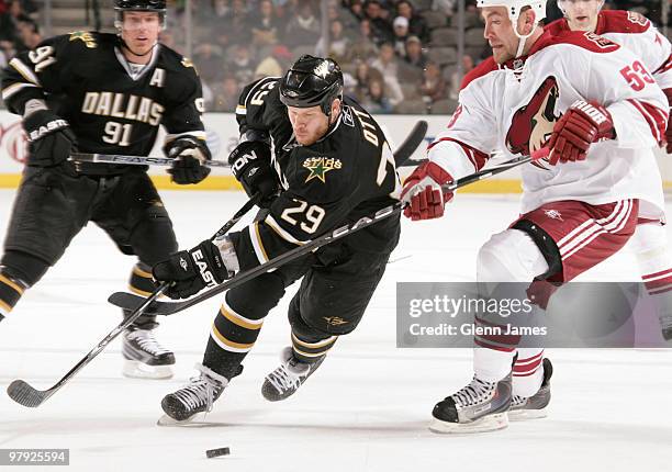 Steve Ott of the Dallas Stars tries to keep the puck away against Derek Morris of the Phoenix Coyotes on March 21, 2010 at the American Airlines...