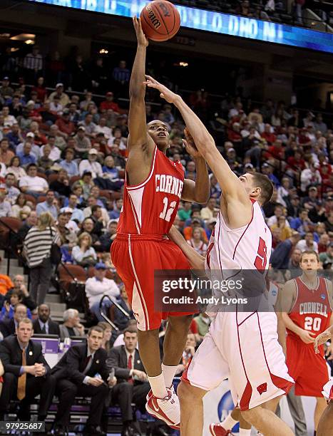 Louis Dale#12 of the Cornell Big Red shoots the ball while defended by Keaton Nankivil of the Wisconsin Badgers during the second round of the 2010...