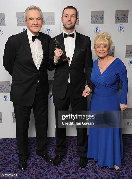 Michael Wynne poses with his 'Best New Comedy' award for 'The Priory' with presenters Larry Lamb and Barbara Windsor and during the Laurence Olivier...