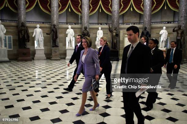 Speaker of the House Nancy Pelosi walks through Statuary Hall on her way to the House Chamber ahead of a historic vote on health care reform at the...
