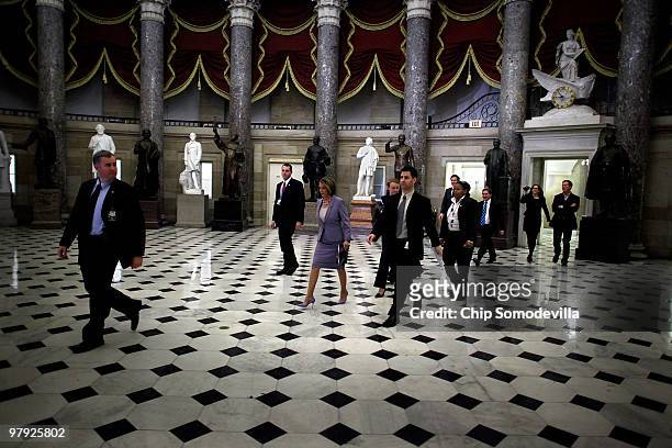 Speaker of the House Nancy Pelosi walks through Statuary Hall on her way to the House Chamber ahead of a historic vote on health care reform at the...